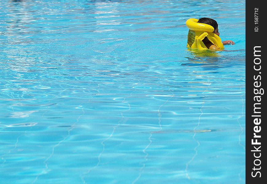 A young swimmer with a life vest