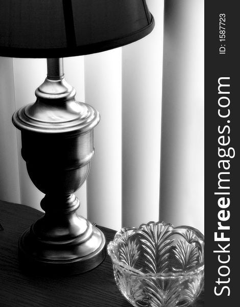 Black and White of Lamp on a table with verticle blinds. Black and White of Lamp on a table with verticle blinds