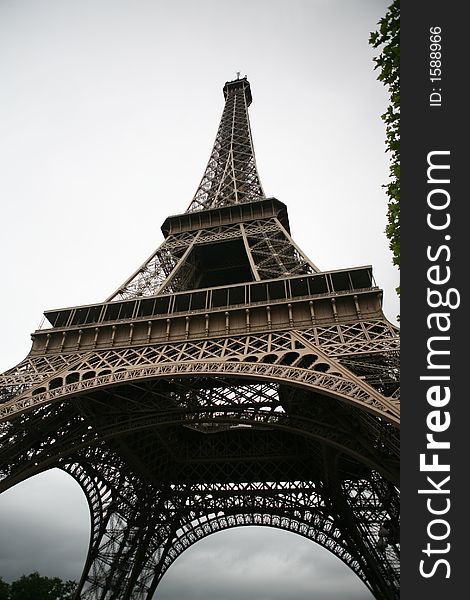 The Eiffel Tower, as seen from the base on an overcast day in July. The Eiffel Tower, as seen from the base on an overcast day in July.