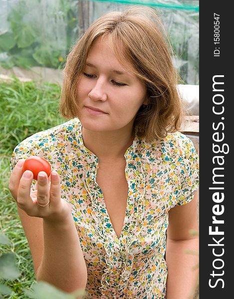 Adorable young farmer is examining harvest