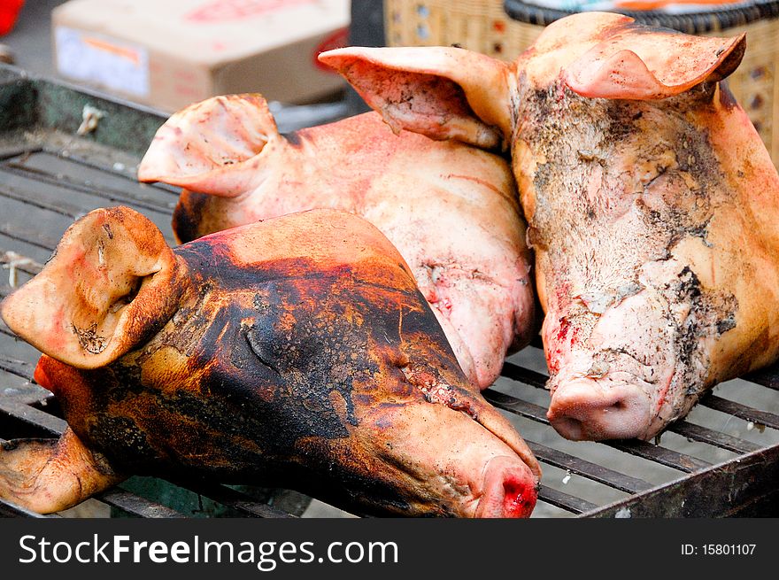 Roasted pork heads at the market in China