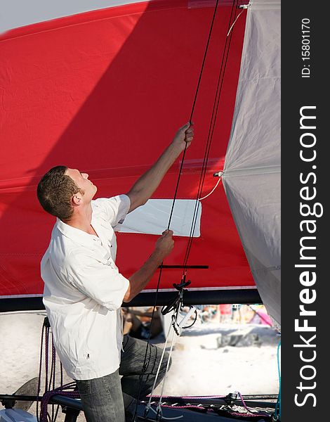 Young man on sea catamaran background