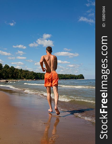 The sports young man on the sea