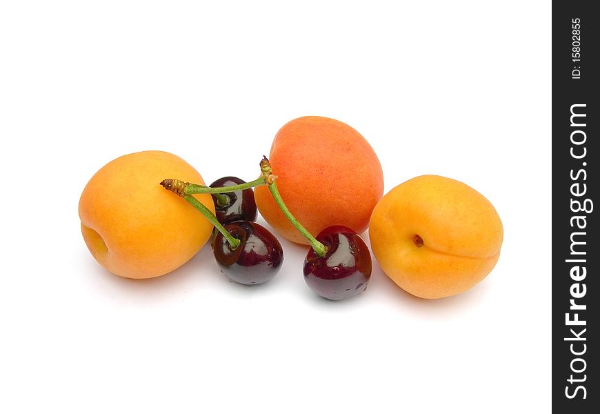 Ripe apricots and cherries are shown in the picture. Ripe apricots and cherries are shown in the picture.