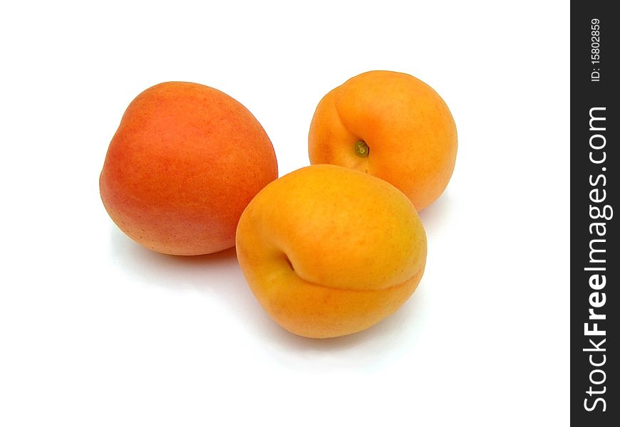 Ripe apricots on a white background are shown in the picture. Ripe apricots on a white background are shown in the picture.