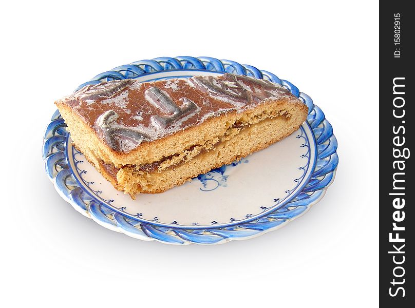 A piece of  gingerbread on the plate is shown in the picture. A piece of  gingerbread on the plate is shown in the picture.