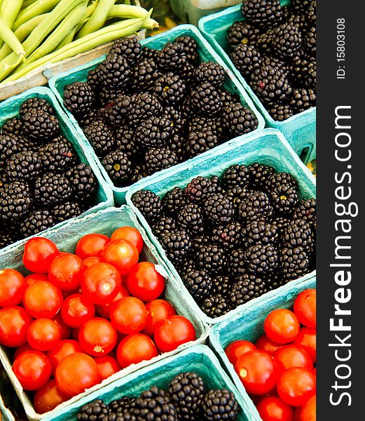 Tomatoes and Blackberries for sale at a farmer's market
