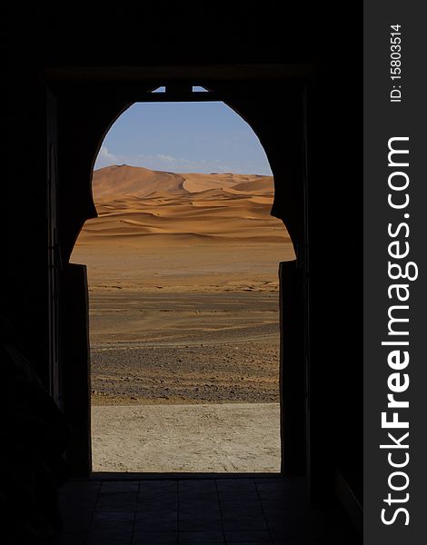 View on Sahara desert through shaped  moroccoan window. View on Sahara desert through shaped  moroccoan window