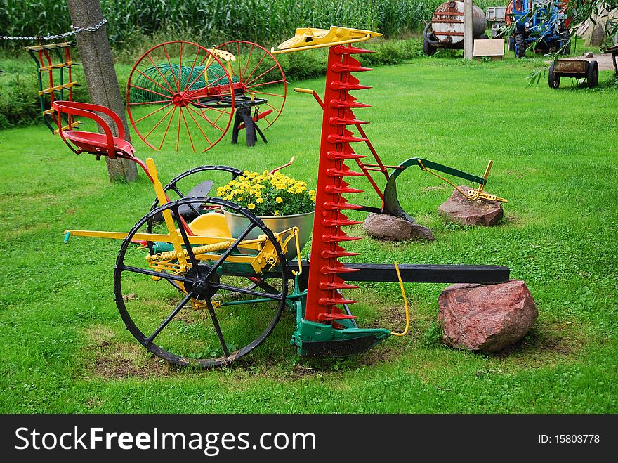 Farm backyard composition with an old agricultural implements