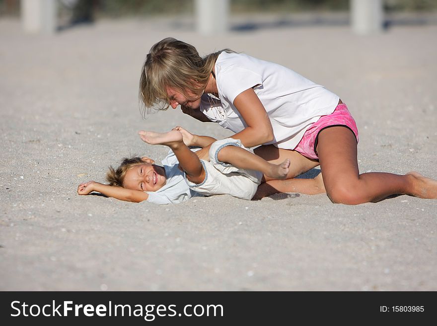 Mother and son playing on beach. Mother and son playing on beach