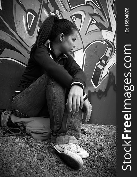 Beautiful Young Girl Sitting Leaning On The Wall