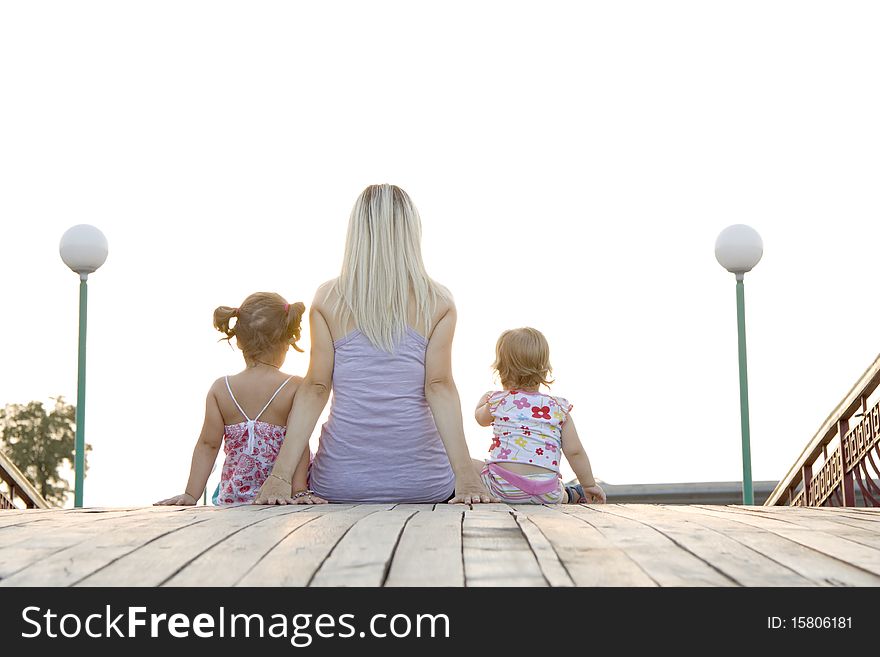 Mum to daughters sit next in the summer evening and admire a decline. Mum to daughters sit next in the summer evening and admire a decline