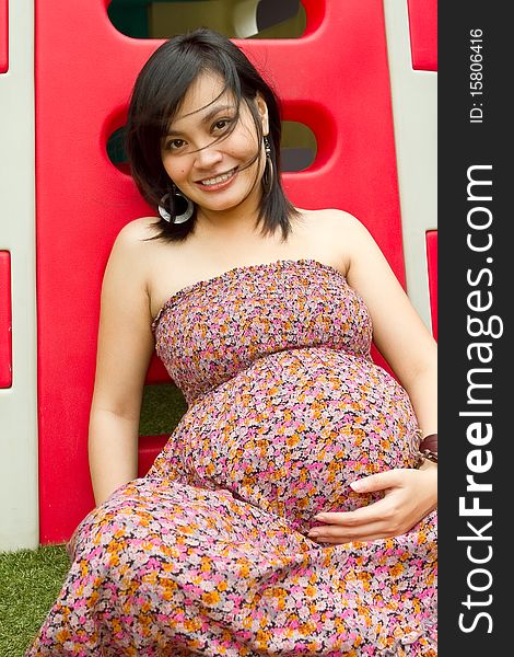 Portrait of healthy Asian ethnic pregnant woman at playground. Portrait of healthy Asian ethnic pregnant woman at playground