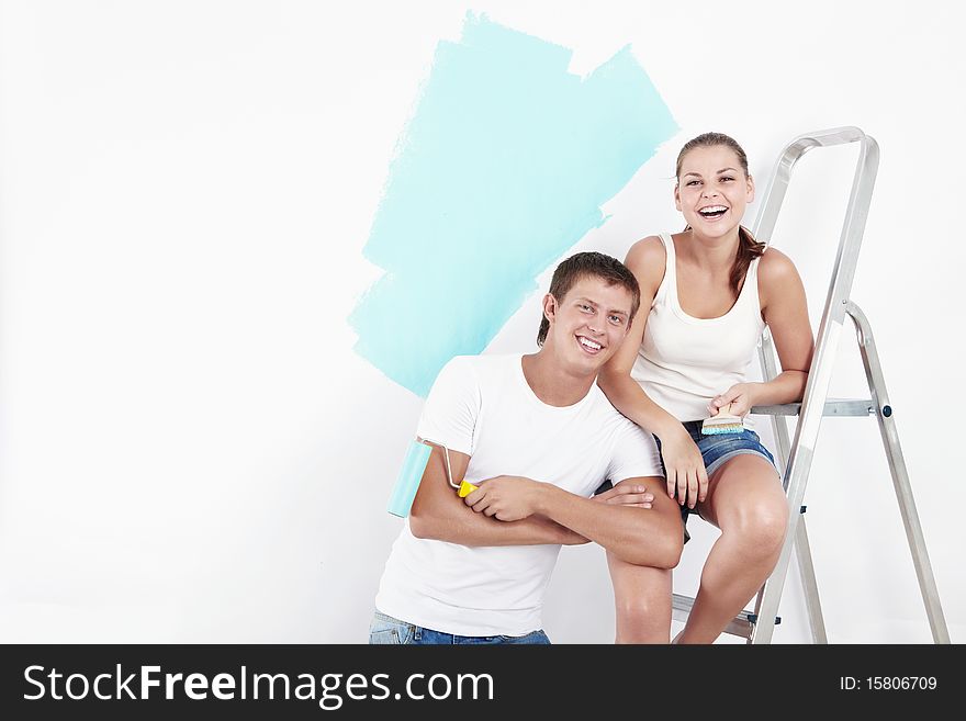 Laughing couple on a background of painted wall. Laughing couple on a background of painted wall