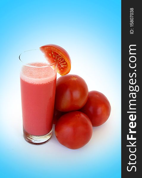 Fresh tomatoes and a glass full of tomato juice. Fresh tomatoes and a glass full of tomato juice.