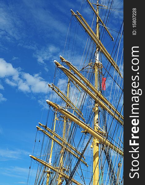 A ship mast against a blue sky