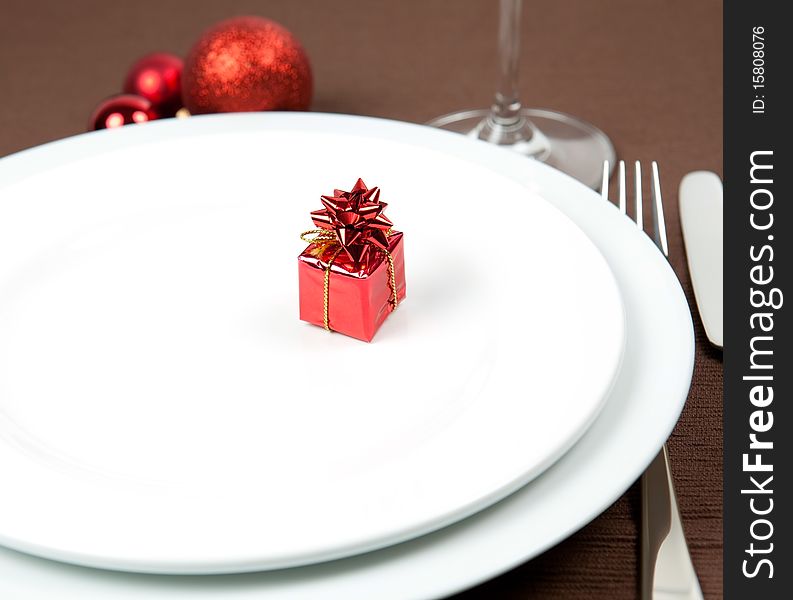 Christmas place setting with gift and cutlery. Christmas place setting with gift and cutlery