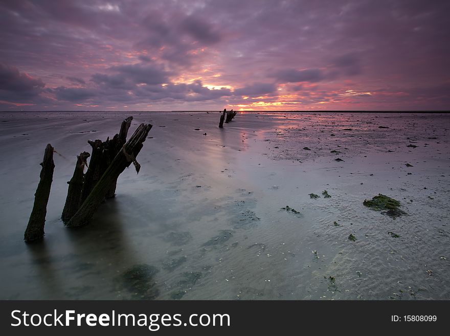 Romantic and dramatic red sunrise over the Wadden sea in the Netherlands. Romantic and dramatic red sunrise over the Wadden sea in the Netherlands