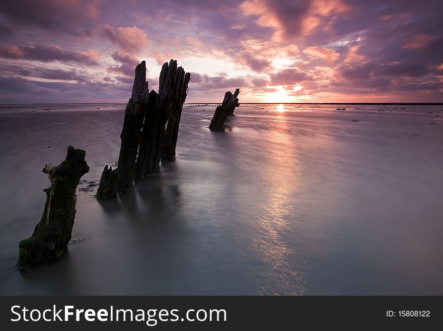 Romantic and dramatic red sunrise over the Wadden sea in the Netherlands. Romantic and dramatic red sunrise over the Wadden sea in the Netherlands