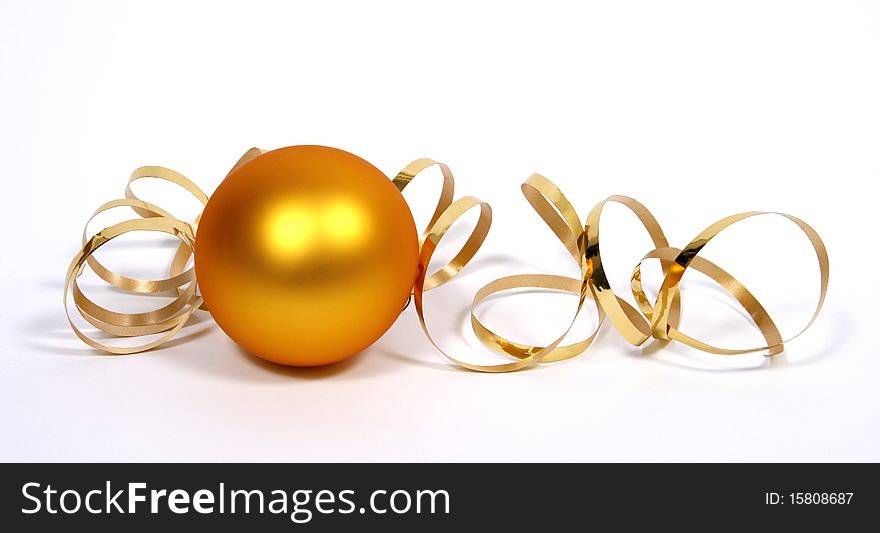 Yellow bauble with the gold ribbon on the white background. Yellow bauble with the gold ribbon on the white background