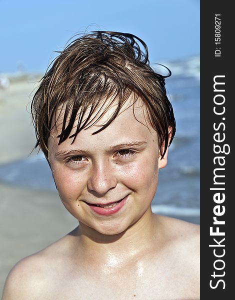 Happy Boy With Wet Hair At The Beach