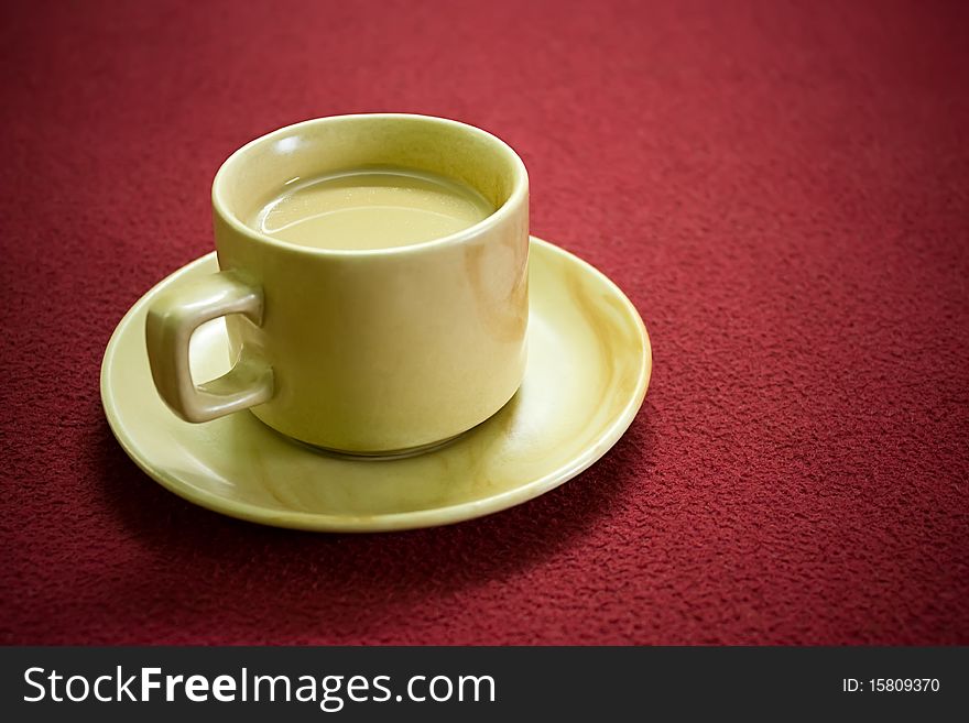 Cup of hot tea over red carpet background. Cup of hot tea over red carpet background