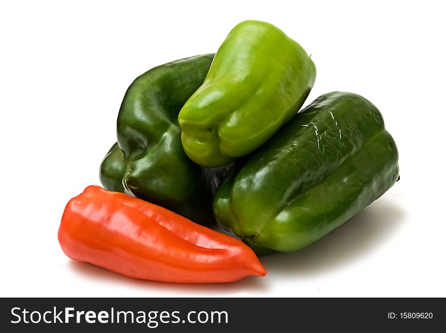 Green and red peppers on white background