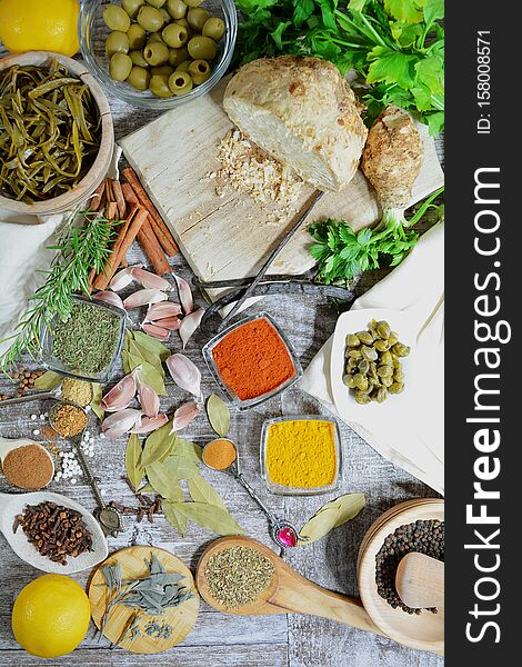 Colorful Mediterranean herbs and spices - top view, grey background. Perfect for a cover photo. Colorful Mediterranean herbs and spices - top view, grey background. Perfect for a cover photo.
