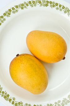 Ripe Golden Mangoes On White Dish Stock Photo