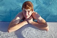 Boy Rests On His Ellbow At The Edge Of The Pool Stock Images