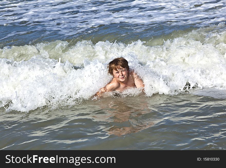 Child has fun in the waves