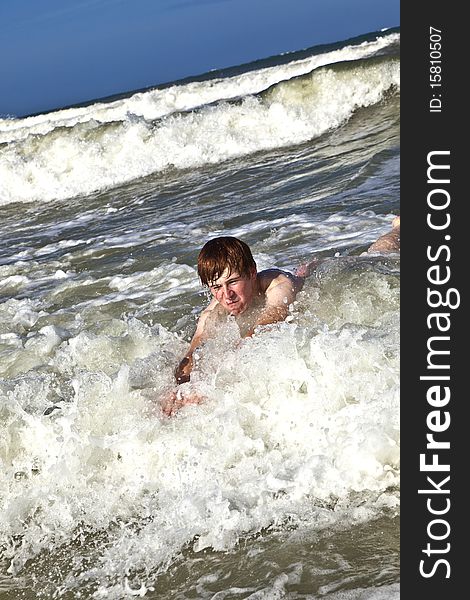 Child has fun in the waves of the ocean