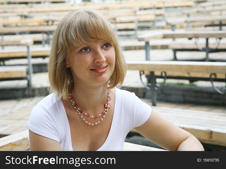 The smiling young woman in park. The smiling young woman in park