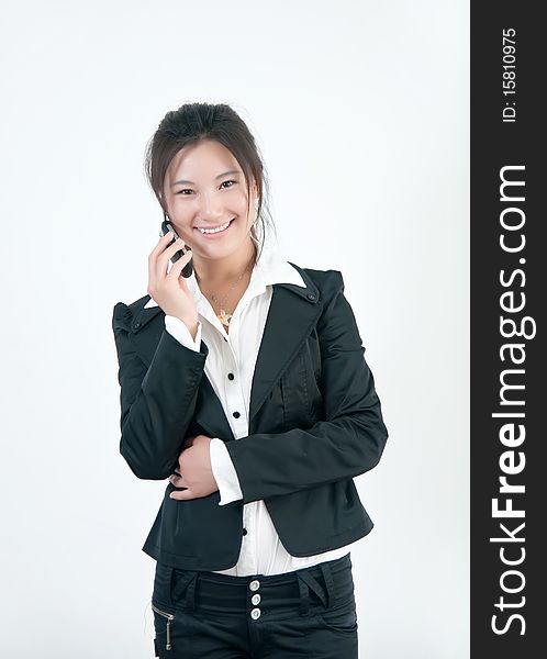 A Beautiful Asian business woman is on her cell phone. A Beautiful Asian business woman is on her cell phone