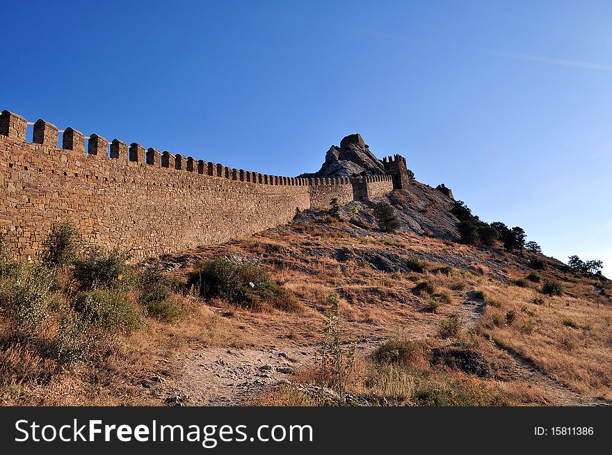 Age-old beautiful fortress wall with the loop-holes of the Genoese fortress in the Crimean mountains of Ukraine