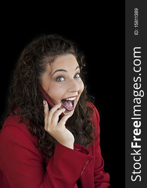 A beautiful young business woman on phone with a surprised expression on her face. A beautiful young business woman on phone with a surprised expression on her face