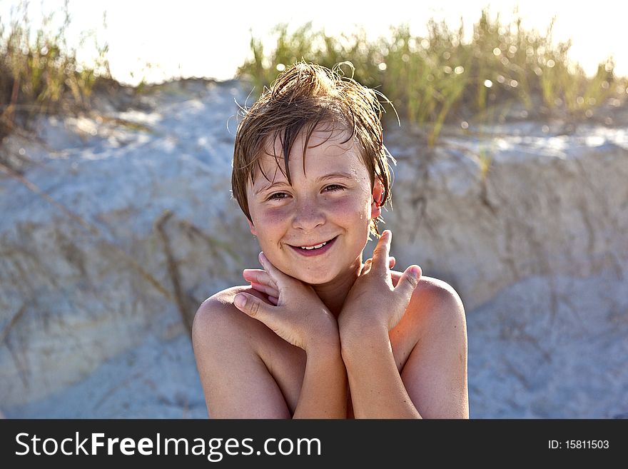 Young happy smiling boy at the beach