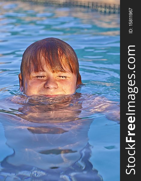 Young child has fun in the outdoor pool