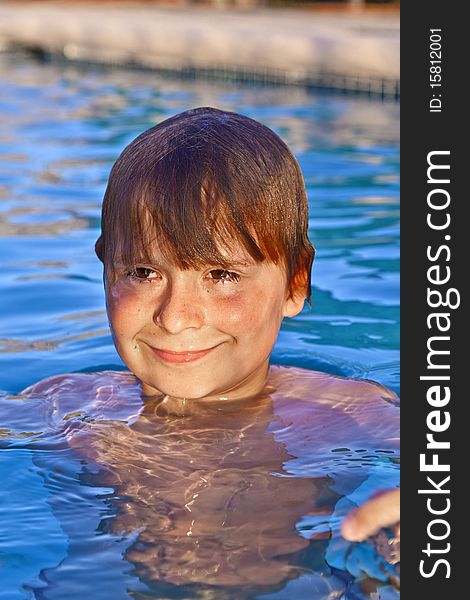 Smiling child has fun in the outdoor pool