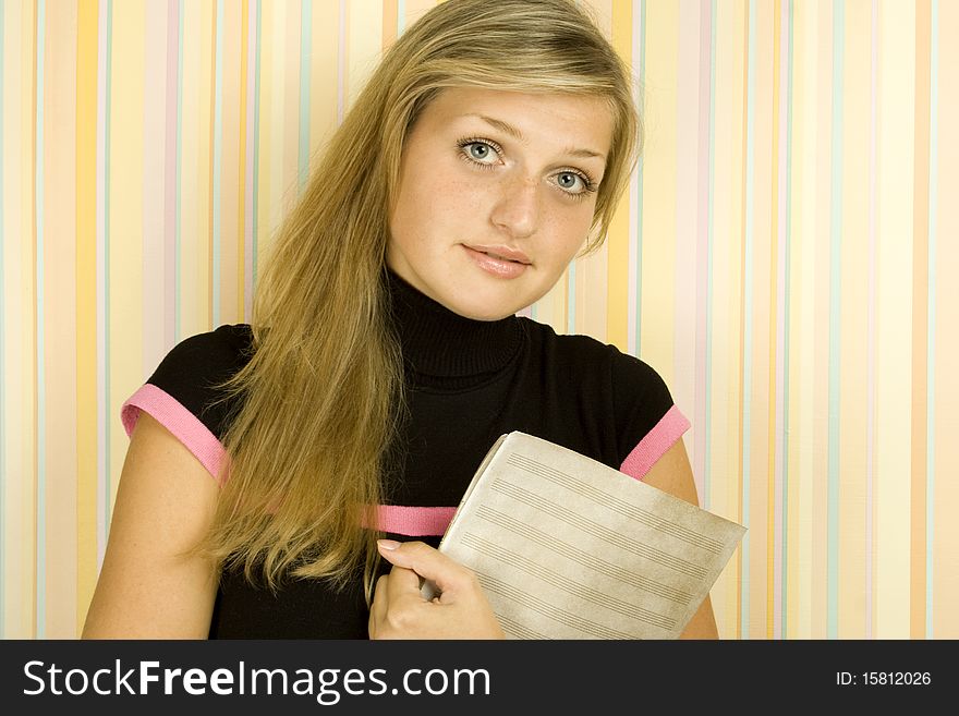 Young beautiful girl smiling in a room sheet with notes. Young beautiful girl smiling in a room sheet with notes.