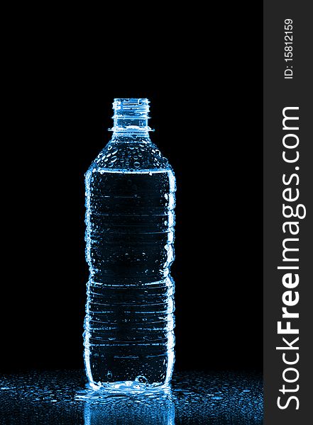 Plastic bottle of water isolated on black