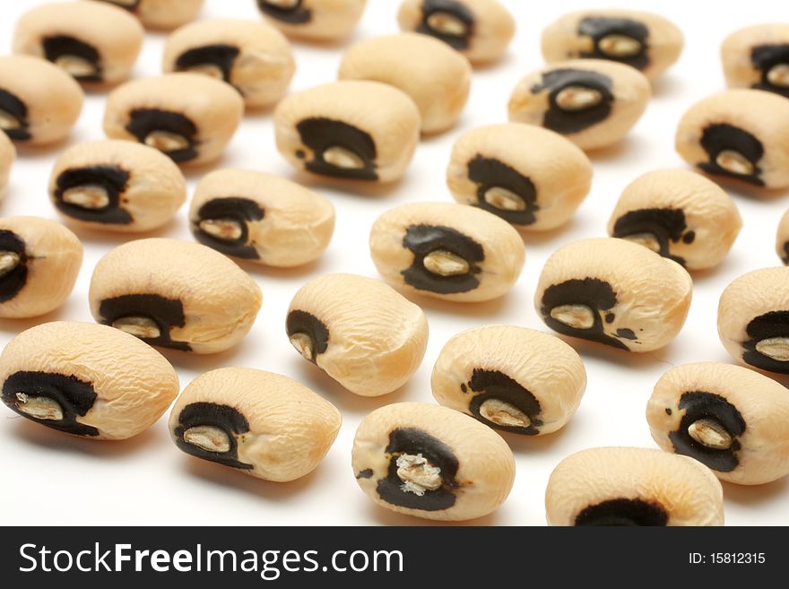 Seeds of black eye beans posted several neat rows. Isolated on white background. Seeds of black eye beans posted several neat rows. Isolated on white background.