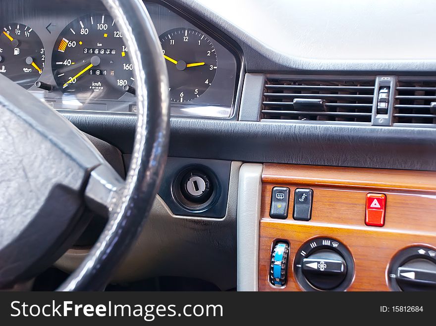 Car interior with dashboard, wheel and controls