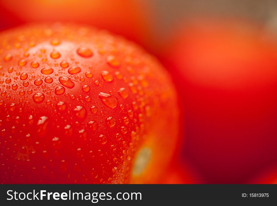 Macro of Fresh, Vibrant Roma Tomatoes in Metal Colander Abstract.