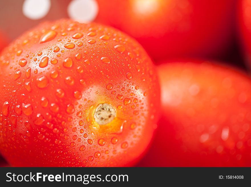 Macro of Fresh, Vibrant Roma Tomatoes in Colander with Water Drops Abstract.