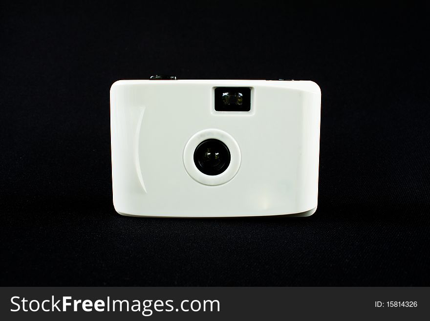 White digital camera isolate on black background