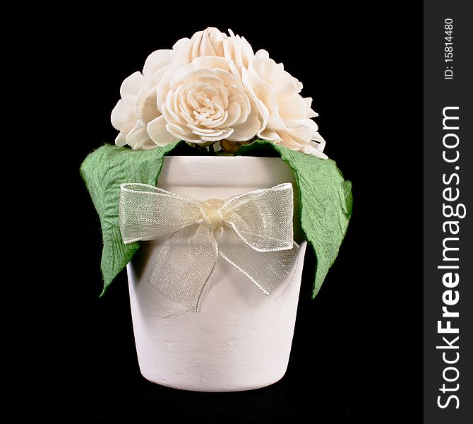 Gift,jasmine and flowerpot on black background