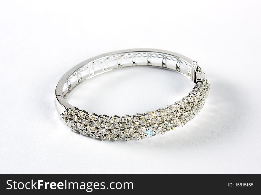 Diamond bracelet with many stones on reflective background