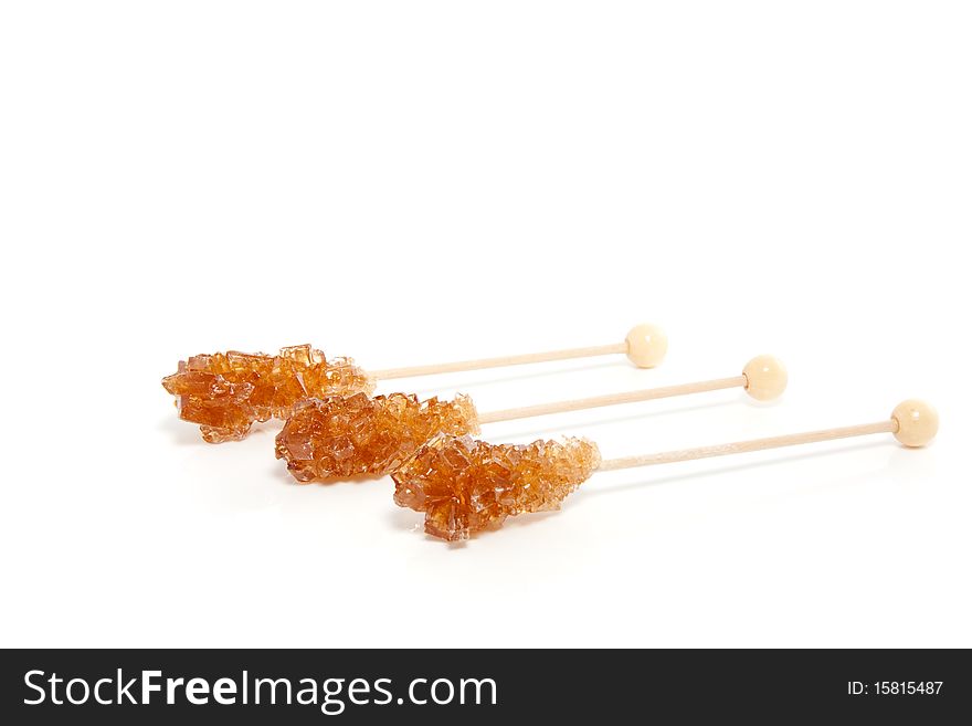 Three brown sugar sticks isolated over white