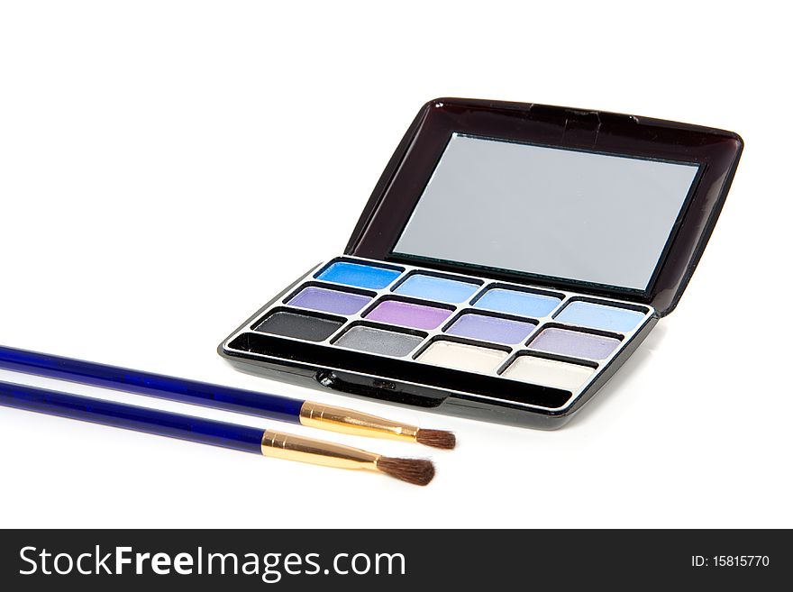 A make-up box with two brushes isolated over white